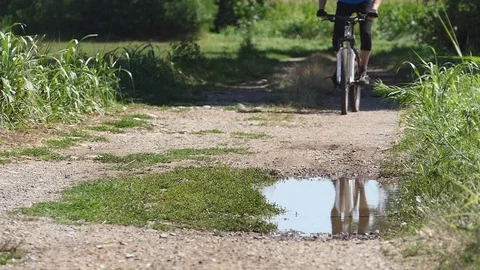 Cyclist in slow motion on a puddle Stock Footage 116478508