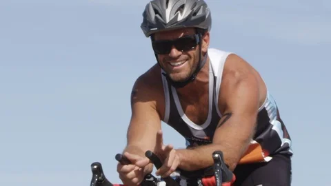 A cyclist smiling at the camera in slow motion Vídeo Stock 91720681