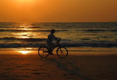 Cyclist at sunset Stock Photos