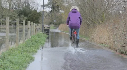 Cyclist through flood Video stock 12657807