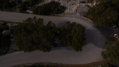 Cyclist topdown on a curvy mountain road drone shot Stock Footage 118823960