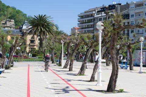 Cyclist using the bicycle lane on the beach dike of San Sebaistian Stock Photos