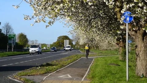 Cyclist using cycle lane york united kingdom Stock Footage 74654939