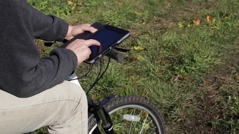 Cyclist using tablet to check map Video stock 75039447