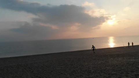 Cyclist walking down the beach to look the sunrise Stock Footage 98689374