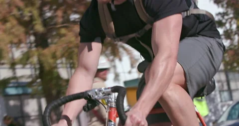 Cyclist watches for traffic while biking on a busy city street Stock Footage 186832926