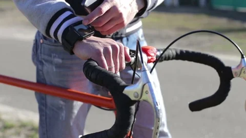 Cyclist works with a smart clock Stock Footage 83197964