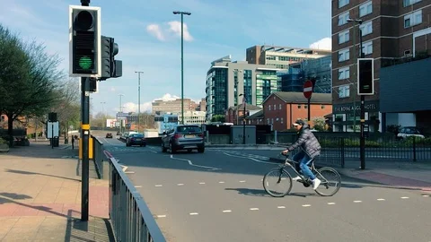 Cyclists and Drivers drive and cycle in harmony throughout Birmingham City Stock-Footage 79074473