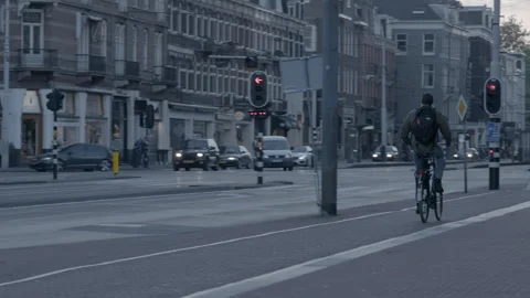 Cyclists and Vehicles Moving along Busy Urban Street Stock Footage 343985865