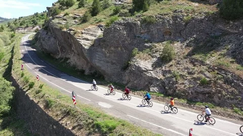 The cyclists on bikes ride up in the mountain Stock Footage 294125398