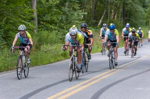 Cyclists at the bottom of a long downhill Stock Photos