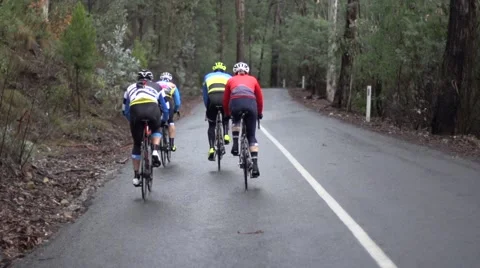 Cyclists climbing road Stock Footage 56292768