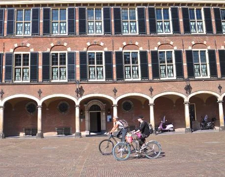 Cyclists in a cobbled piazza. Foto stock