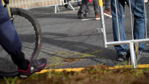 Cyclists crossing the road during a sporting event Stock Footage 197106034