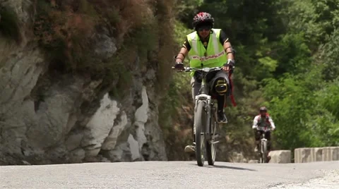 Cyclists cruising through mountain pass Stockbeeldmateriaal 45312831