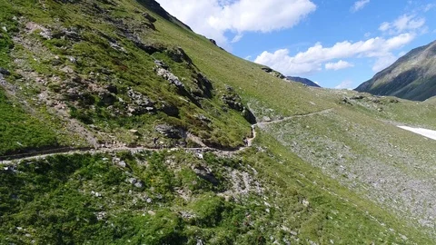 Cyclists descend from the mountain by bicycle. View from a drone Video stock 91683706