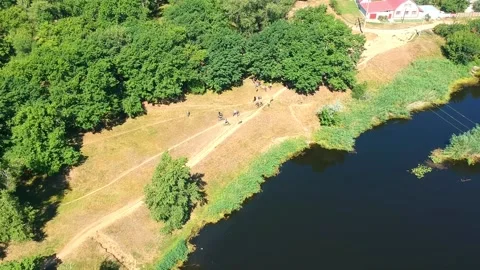 Cyclists in different clothes and protective helmets on a mountain bike Stock Footage 136024545