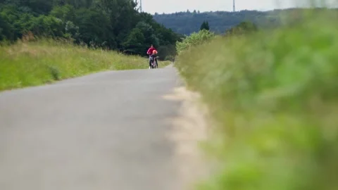 Cyclists exploring serene countryside, exercising and enjoying peaceful Stock Footage 303597826