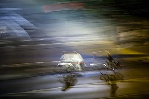 Cyclists Glide Through Berlins Night in Dreamy Blur Stock Photos