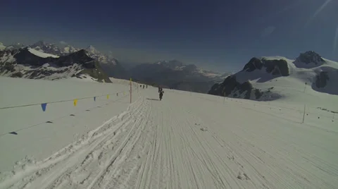 Cyclists going downhill on snow Stock Footage 32907064