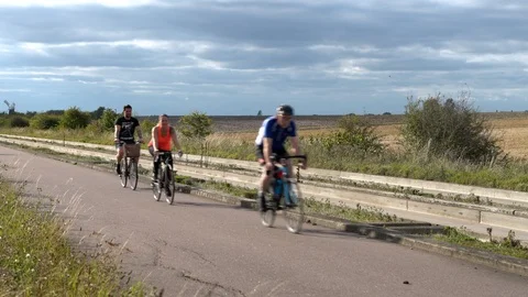 Cyclists on Gudied Busway in Cambridgeshire Stock Footage