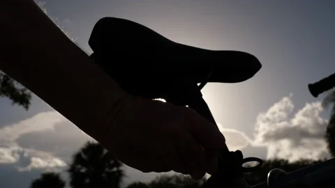 Cyclist's Hand Turning on Rear Light Stock Footage 208815286