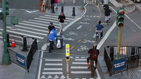 Cyclists at an intersection of a bicycle greenway Video stock 220464186