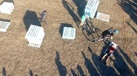 Cyclists jump over man in bicycle aerial HD video. MTB tricks Extreme sport Stock Footage