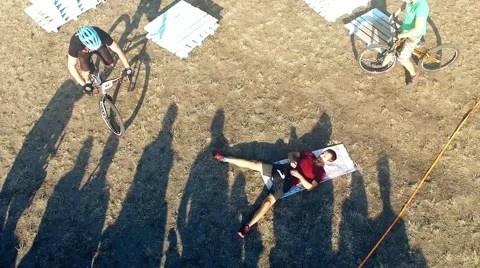 Cyclists jump over man bicycle aerial HD video. MTB tricks Mountain bike trial Stock Footage