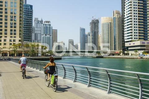 Cyclists on Marina Walk, Dubai Marina, Dubai, United Arab Emirates, Middle East Stock Photos