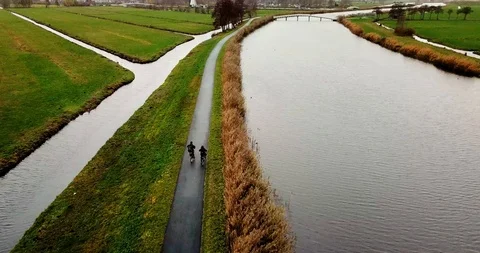 Cyclists next to a canal Stock Footage 101141216