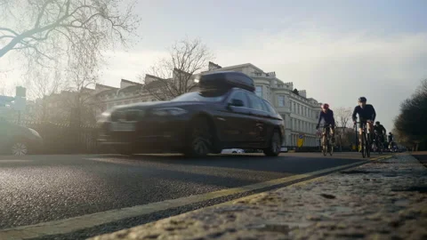 Cyclists pass low angle Stock Footage 145566006