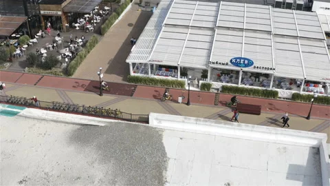 Cyclists pass by the restaurant Video stock 134750320
