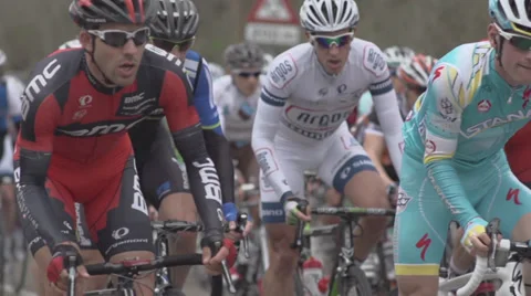 Cyclists Passing By in Slow Motion Stock Footage 34317643