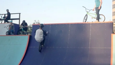 Cyclists perform a joint stunt and one of them falls 스톡 동영상 103244534