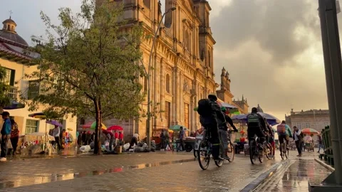 Cyclists on placa bolivar in the rain Stock Footage 239418110