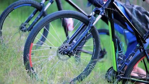 Cyclists pushing bikes up a hill Stock Footage 76593830