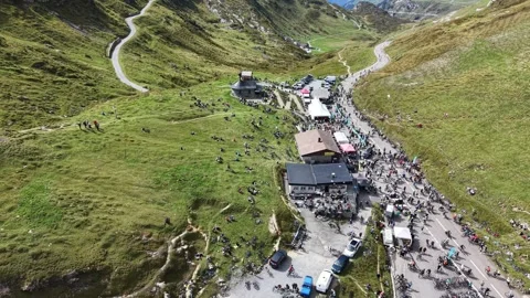 Cyclists Resting on Alpine Summit After Mountain Ride Stock Footage 345496002