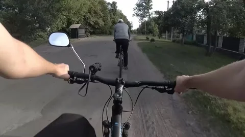 Cyclists ride on the road on a summer evening Stock Footage 132819947