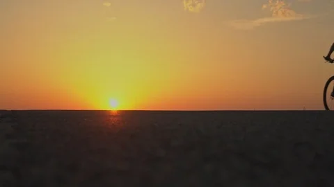 Cyclists ride in the sunset. slow motion Stock Footage 89381888