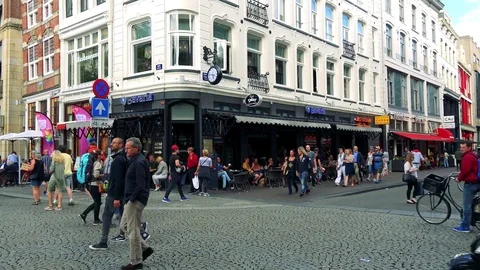 Cyclists ride through an intersection of a busy street in a traditionally 動画素材 73958017