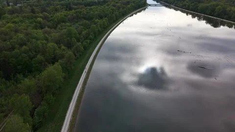 Cyclists riding along large river with vast landscape aerial view Stock-Footage 334027745