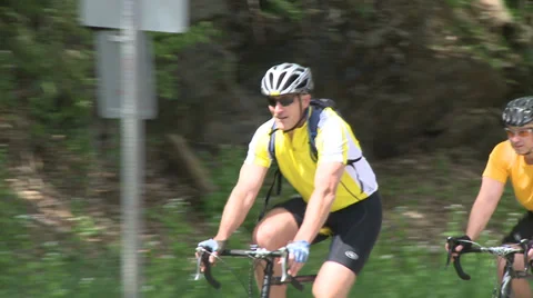Cyclists riding alongside road (5 of 9) Video stock 32031341