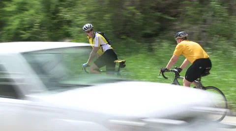 Cyclists riding alongside road (6 of 9) Stock Footage 32031344