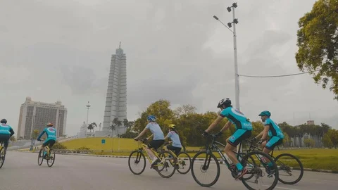 Cyclists riding on road in front of monument in havana cuba Stock Footage 88763059