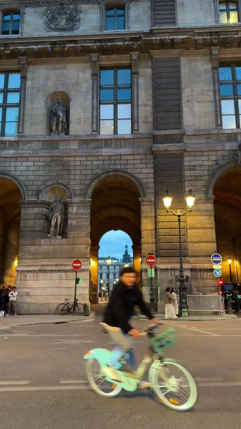 Cyclists riding on Rue de Rohan in Paris Stock Footage 337783099