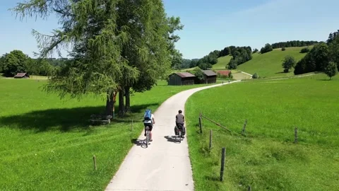 Cyclists riding through a hilly landscape in Bavaria Video stock 198146209