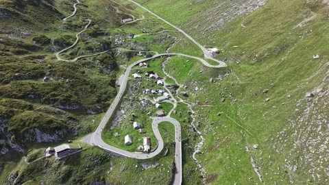 Cyclists Riding Tight Switchbacks at Klausenpass Stock Footage 345496435