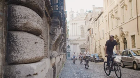 Cyclists in slow motion on Italy side street Video stock 94089119