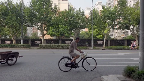 Cyclists on the streets of Shanghai Stock Footage 124587086